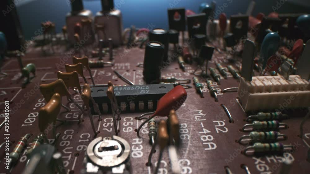 Poster dolly macro shot of orange vintage circuit board with micro networking components