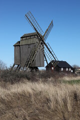 Fototapeta na wymiar Degerhamn / Sweden - April 20 2013: Windmill at the south tip of island Oeland (Öland) in south-east of Sweden