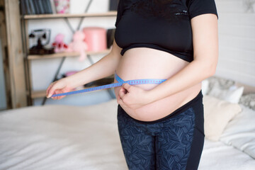 Pregnant woman measuring her belly. Healthy pregnancy. Health pregnancy lifestyle.