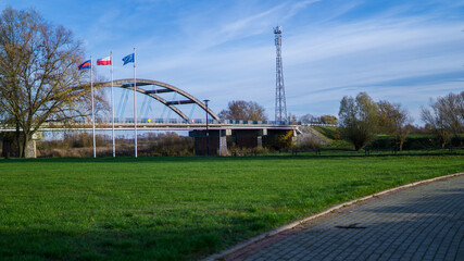 Fototapeta na wymiar View of bridge and flags of Poland and European Union.