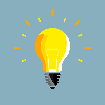 Colored light bulb with a bright ray on a blue background. A light bulb is always a good idea.