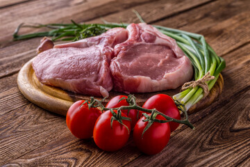 fresh raw new-york steak on wooden Board on wooden background with salt and pepper in a rustic style.