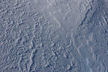 Background: Snow surface in Swiss Alps - nice waves in the frozen snow