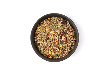 A mixture of dried herbs and peppers for cooking in a round bowl on a white background. The view from the top.