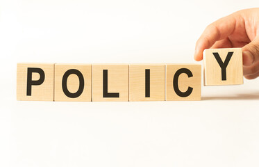 Word policy. Wooden small cubes with letters isolated on white background with copy space available.Business Concept image.