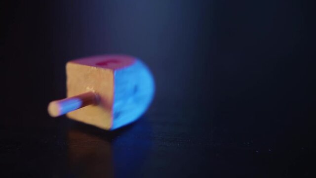 Dreidel spinning on a wooden table