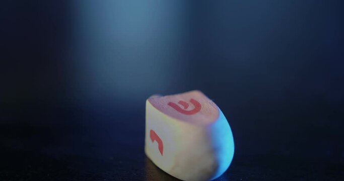 Dreidel spinning on a wooden table