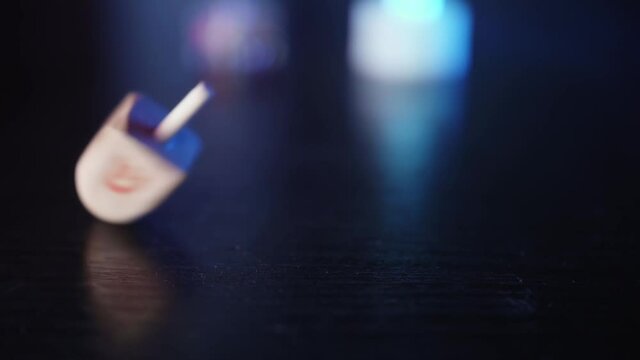 Dreidel spinning on a wooden table