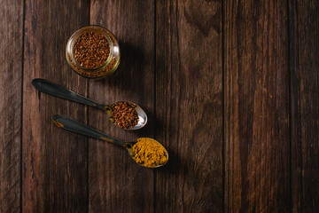 Spices used for healthy cooking. Spoons with curry and flaxseed for cooking.