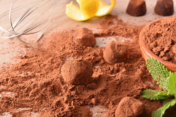 Making chocolate truffles wrapped in cocoa powder and ingredients elevated