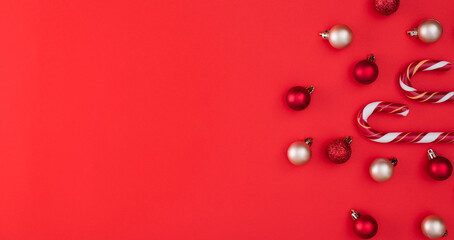 Candy cane and globes. Red Christmas background. top view with copy space