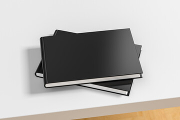 Horizontal or landscape black hardcover book stack mockup on the white table.