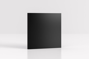 Hardcover square black mockup book standing on the white background.