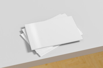 Horizontal or landscape white magazine or brochure stack mockup on white table
