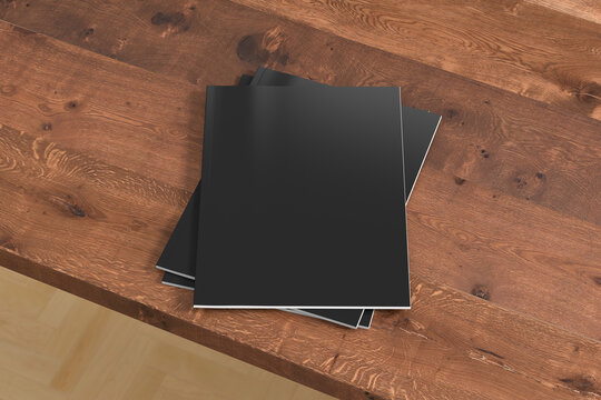 Vertical black magazine or brochure stack mockup on wooden table