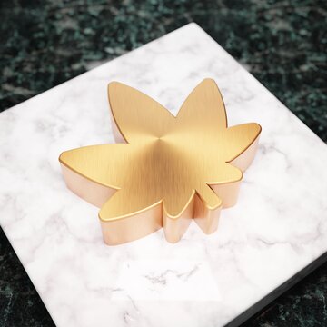 Cannabis icon. Bronze Cannabis symbol on white marble podium.