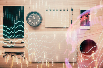 Double exposure of forex graph hologram over desktop with phone. Top view. Mobile trade platform concept.