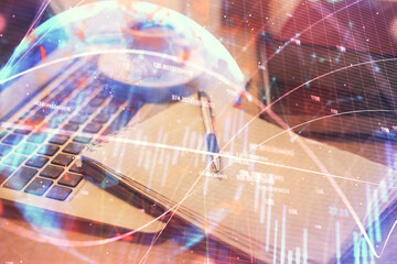 Double exposure of forex chart drawing and desktop with coffee and items on table background. Concept of financial market trading