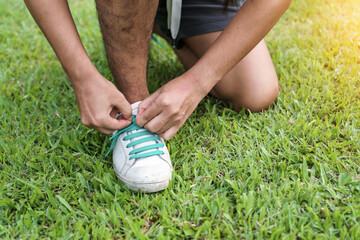 Young asian man prepare shoe before running in the morning, Selective focus, Exercise and healthy concept,