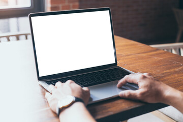 computer blank screen mockup.hand man work using laptop with white background for advertising,contact business search information on desk at coffee shop.marketing and creative design