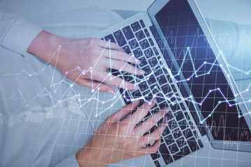 Double exposure of woman hands working on computer and forex chart hologram drawing. Top View. Financial analysis concept.