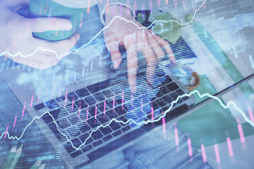 Double exposure of woman hands typing on computer and forex chart hologram drawing. Stock market invest concept.