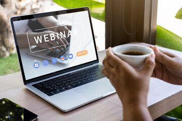 Person using a laptop computer for online training webinar. E-learning browsing connection and cloud online technology webcast concept. Laptop mockup with clipping path on screen.
