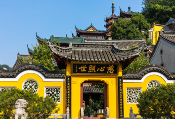 Architecture complex of traditonal Chinese style with symbolic Cishou Pagoda in historic Buddhist Jinshan Temple, first established in 4th-CE, Zhenjiang, Jiangsu, China. Heritage & tourist attraction.