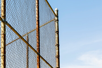 Rusty Chain Link Fence against a Blue Sky