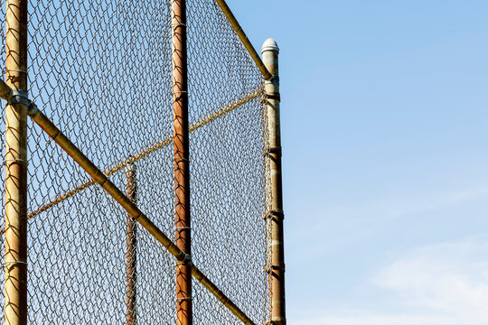 Rusty Chain Link Fence Against A Blue Sky