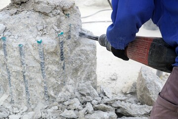 Worker use rotary extract concrete to extract concrete piles as part of the foundation construction of the power plant.