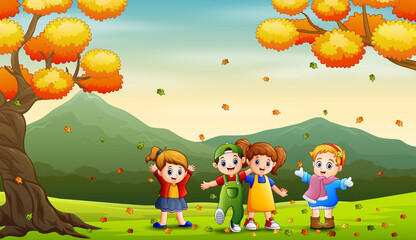 Happy kids playing outdoors in autumn