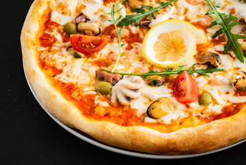 seafood pizza on the black background