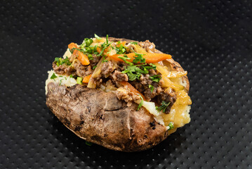 baked potato on the black background