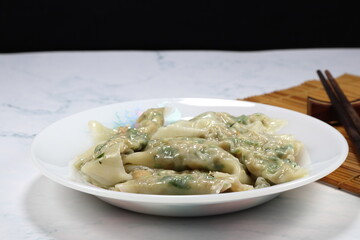Classic steamed wonton on the plate. Famous traditional Dim sum appetizer menu in Chinese restaurant. 