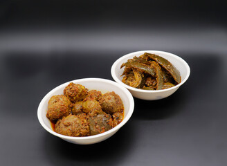 Group photograph of indian pickles or achar like amla pickle and mango pickle, aavla or aam ka achar sarved in white ceramic bowl, selective focus