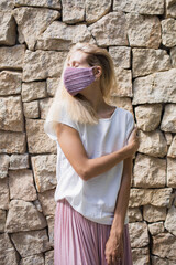 beautiful blond woman posing in pink silk skirt and white silk shirt and pink velvet fabric handemademask