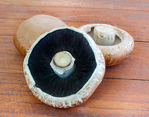 portobello mushrooms on a wooden background.