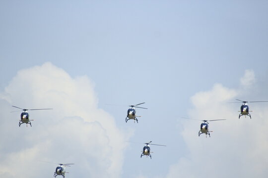 Helicopters On Formation With Blue Sky Background