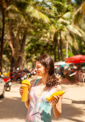 Happy woman in drinking mango shake on vacation, Thailand. - 394058862