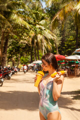 Happy woman in drinking mango shake on vacation, Thailand. - 394058864