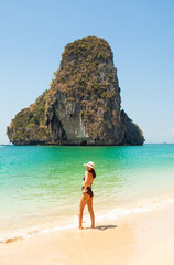 Woman in swimsuit and hat on the beach, Krabi, Thailand. - 394059087