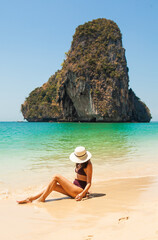 Woman in swimsuit and hat on the beach, Krabi, Thailand. - 394059098