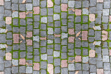 Cobblestone paved with mosaic of different colors on an old road