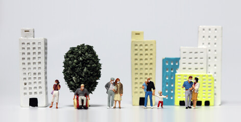 A variety of miniature people wearing masks. The concept of life post-Covid-19.
