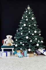 New Year's holiday Christmas tree decor with gifts and interior garlands