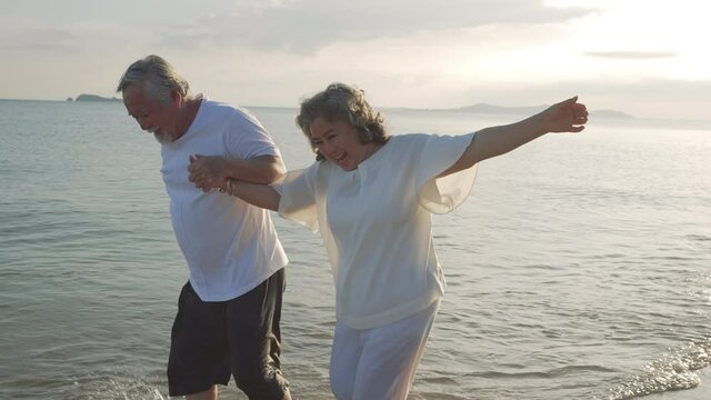 Happiness Asian couple senior elderly retirement resting and running beach