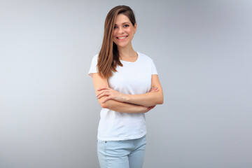 Woman wearing white t shirt with copy space standing with crossed arms.