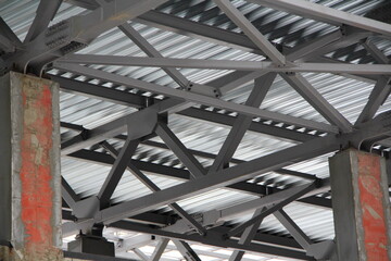 Fototapeta premium An old steel metal farm. structure of metal structure of frame-type industrial building. Lightweight metal frame construction.