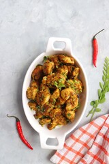 Stir fried taro roots. Arbi ki sabji, Taro roots masala curry. Arbi Masala. Garnished with coriander, red chili & curry leaves. copy space.